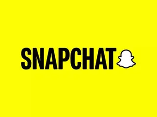 Wireless store owner filming a vertical Snapchat ad video showing an accessory bundle on the counter