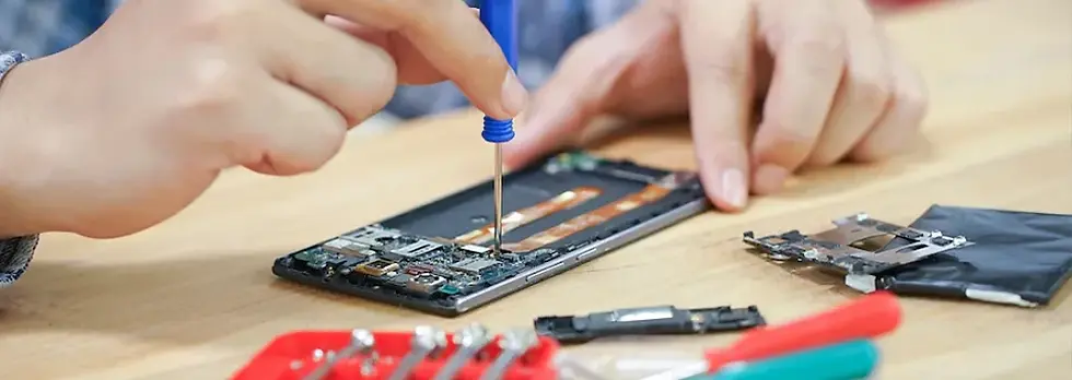 Wireless dealer reviewing repair parts shipments and supplier quality control checklist at a repair bench