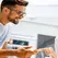 Wireless store manager calmly speaking with an angry customer at the counter using a de-escalation script
