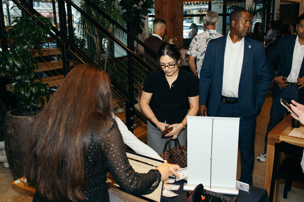 People interacting at an indoor event or gathering.