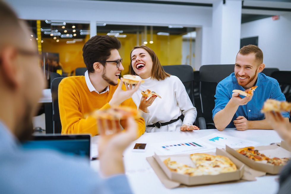 employees laughing and eating lunch at the workplace cafeteria