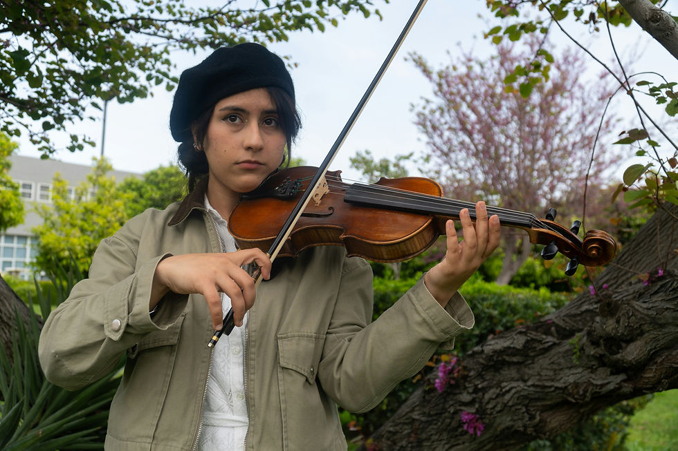 Young woman playing violin outdoors, looking uncertain, illustrating the unwitnessed hours of practice behind any skill