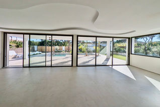 Interior lounge with panoramic glass sliding doors.