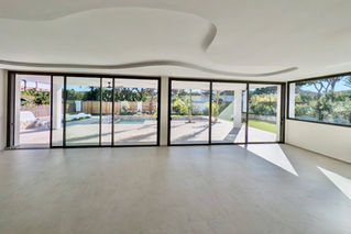 Interior lounge with panoramic glass sliding doors.