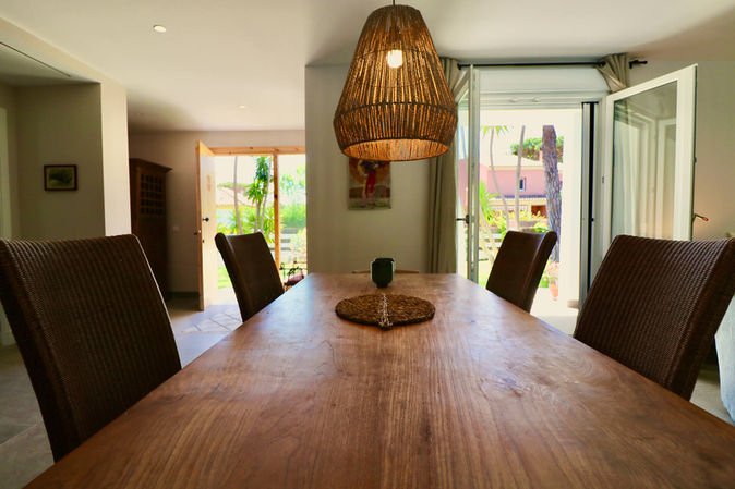 Bright dining area with sliding doors to garden.