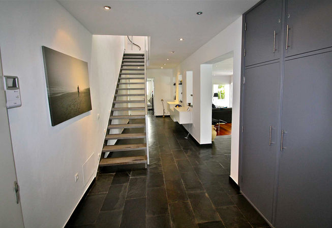 Hallway with stairs and view into open-plan area