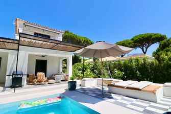 Pool area with lounge chairs and shaded terrace in Roche.