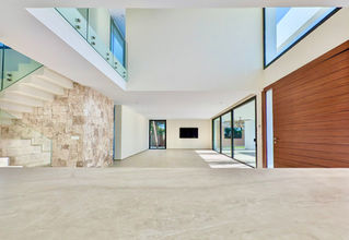 Spacious open-plan living room with high ceilings in modern villa