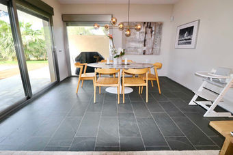 Dining area with round table and garden-facing doors