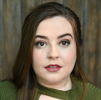 headshot of Marinda Convis, wearing green