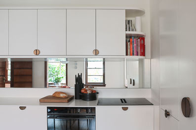 South Yarra apartment. heritage apartment renovation. Corian benchtop, integrated kitchen. Orange sofa, sash windows. Outdoor balcony. Bronze fixtures. Brodware tapware. 
