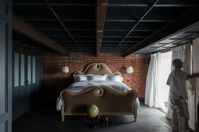 Melbourne luxury apartment . Apartment renovations. Heritage renovation. Architecture. Interior Design. timber ceiling paneling. Fireplace in bedroom. 