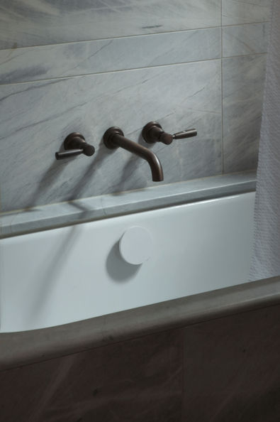 South Yarra apartment. heritage apartment renovation. Corian benchtop, integrated kitchen. Orange sofa, sash windows. Outdoor balcony. Bronze fixtures. Brodware tapware. 