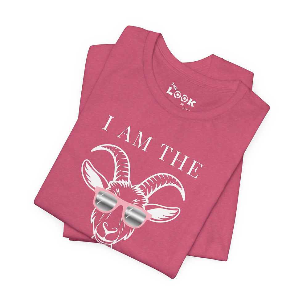 Thumbnail: Folded pink I Am The GOAT t shirt close up showing goat head sunglasses graphic