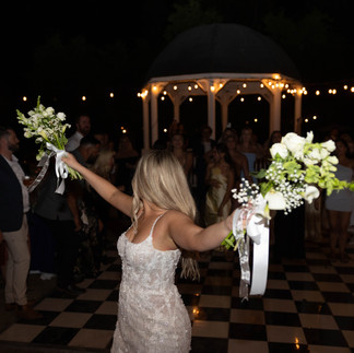 bride with two bouquets for her bouquet toss