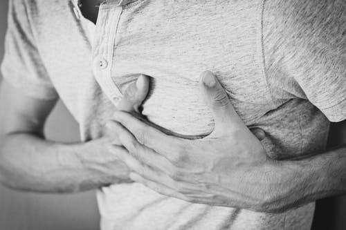 How to recognise a heart attack man holding chest
