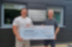 Event directors Stephen Hoather and Jonathan Hirst presenting a cheque for £7,500 to Martin House!