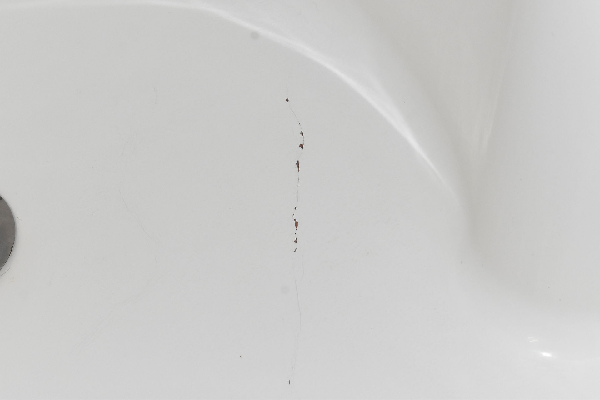 Damaged shower insert that can be repaired before resurfacing.
