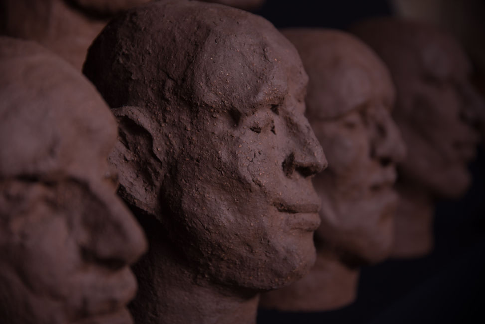 Groep of 14 dark terracotta biscuit sculpture by Louise Blankevoort