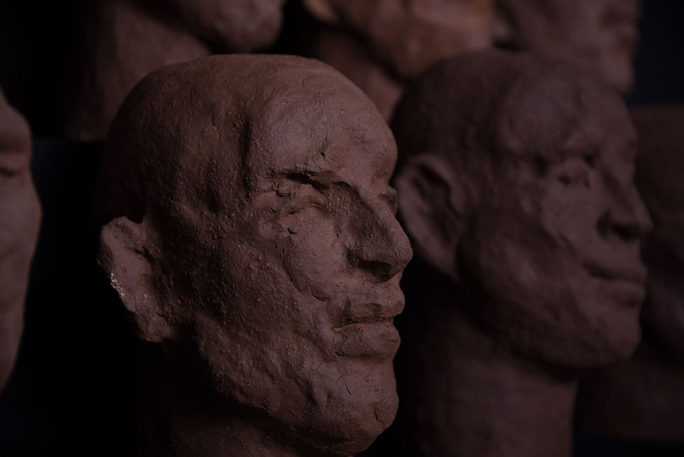 Groep of 14 dark terracotta biscuit sculpture by Louise Blankevoort