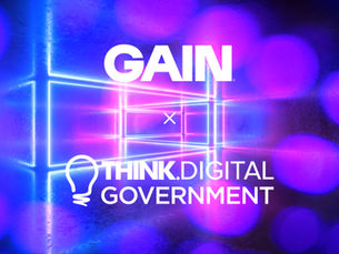 A wide banner image with a dark background featuring blurred purple and blue bokeh circles and glowing neon geometric shapes. In white text, 'GAIN' appears at the top centre, followed by a lowercase 'x' indicating a partnership, and below that the 'Think.Digital Government' logo, which includes a lightbulb icon to the left of the text.