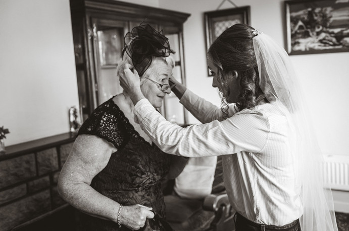 A bride fixed her mothers hat on the wedding morning in Cork