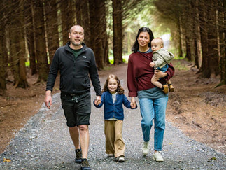 a family walking through a forest in west cork