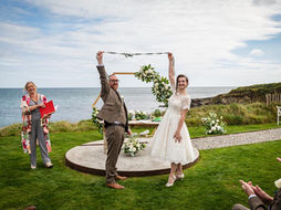 a newly married couple celebrate after their wedding ceremony at Dunmore House Hotel