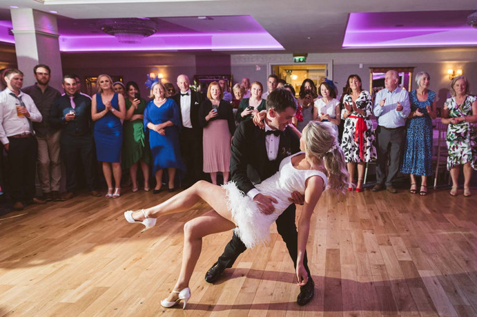 A groom dips her bride during their first dance at Dunmore House Hotel