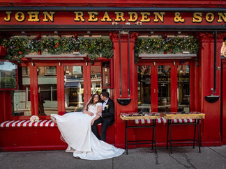 a bride and groom relax outside Rearden's Pub in Cork City