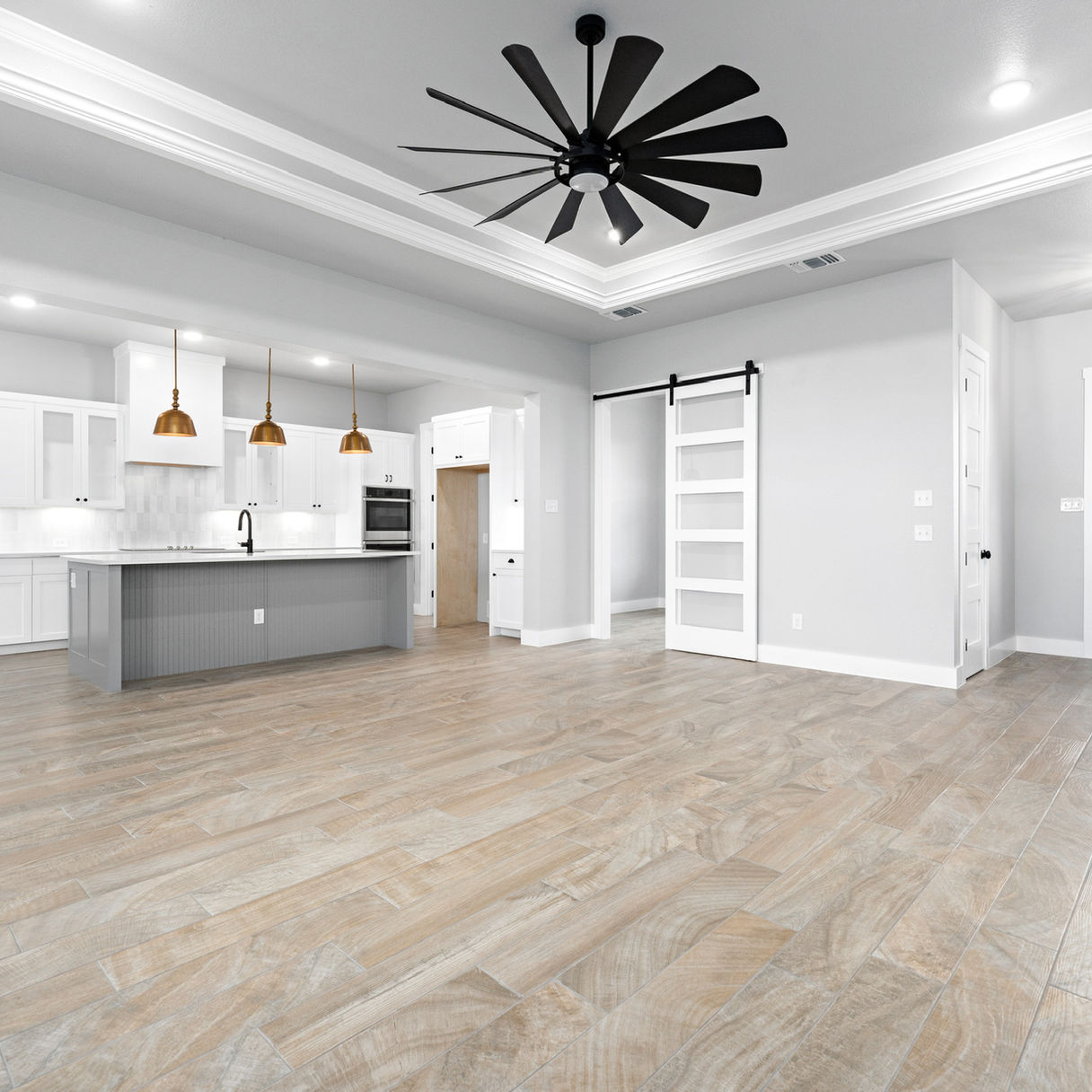 Custom kitchen in Salado, TX, with a large island, quartz countertops, and high-end finishes, designed for modern living.