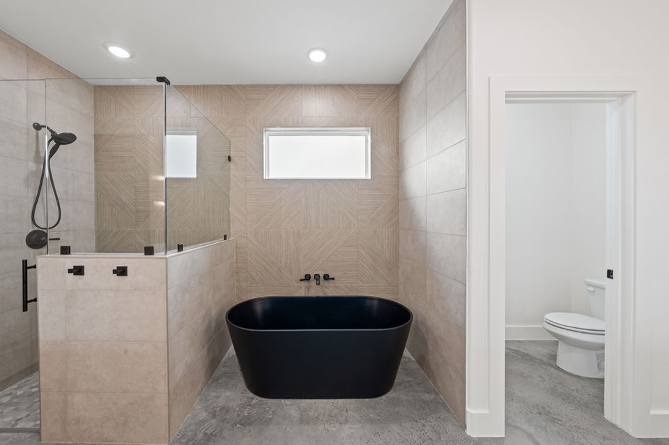 Luxury master bathroom in Salado, TX, with a walk-in shower, double vanity, and spa-like ambiance.