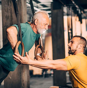 Older man training with gymnastic rings
