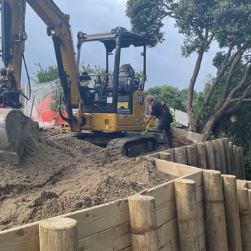 Yellow digger on a construction site with The Digger Man Civil