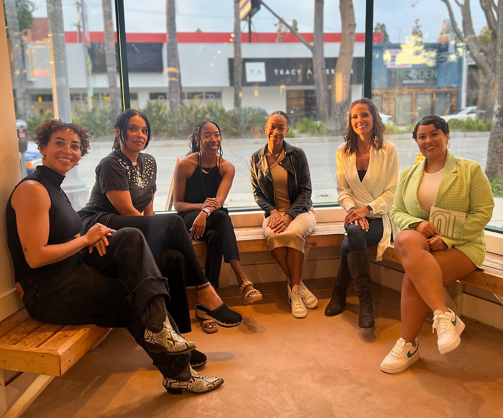 diverse group of women sitting down in front of window