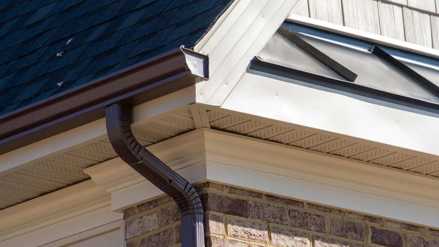 dark-brown-gutter-system-downspout.webp