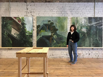 Artist in front of her paintings