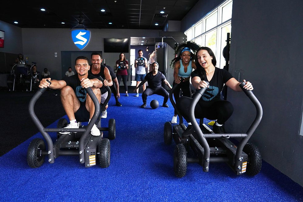 The team pushing the sleds at Sweat 440 Coral Springs