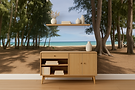 Modern wooden sideboard with drawer and cabinet storage, styled with books and ceramics, set against a Hawaiian beach mural backdrop.