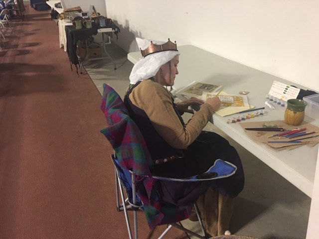 Baroness Bebhinn finishing some beautiful scrolls!