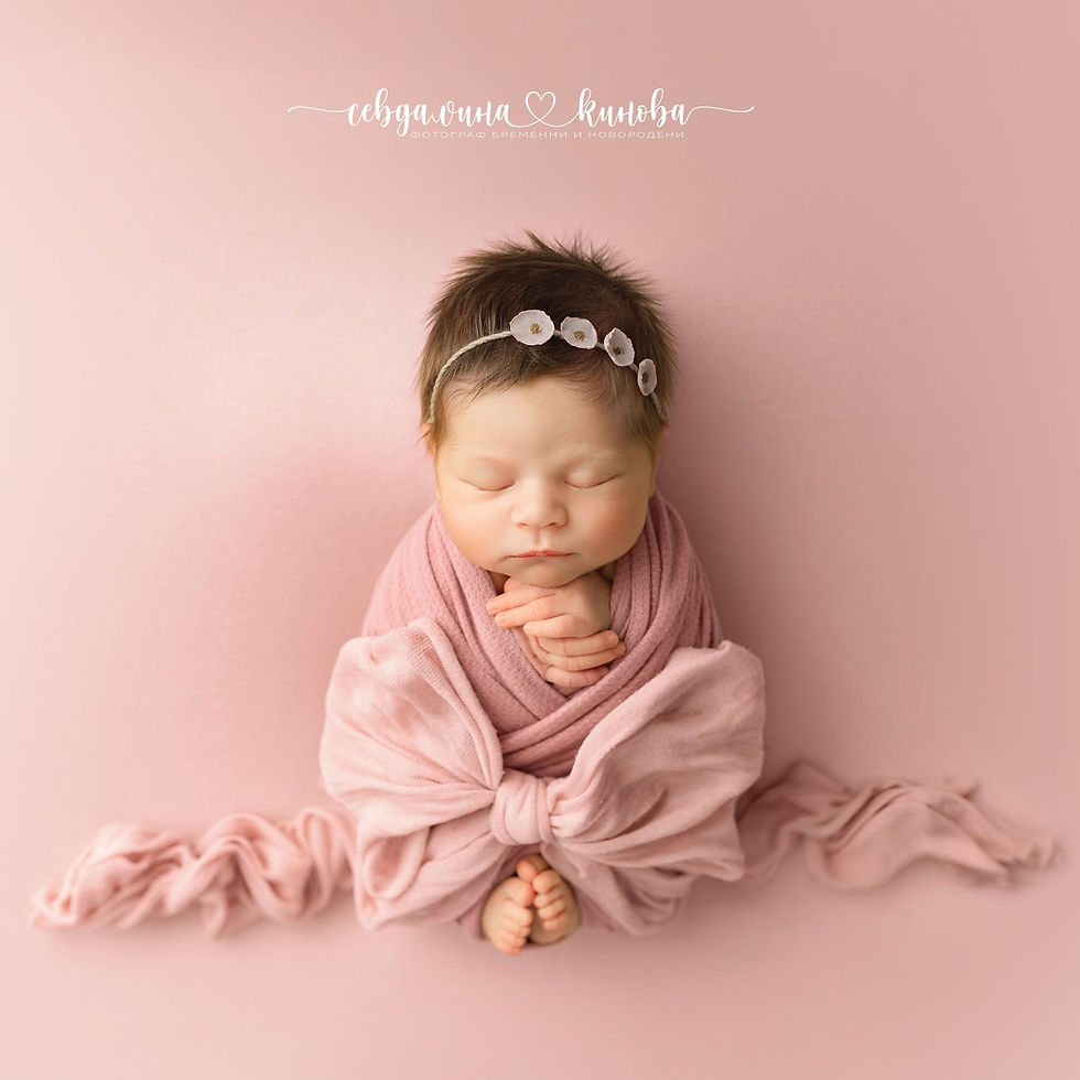 Sleeping newborn wrapped in pink blanket on blush background, with floral headband; white Cyrillic photographer text above.