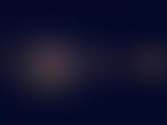 Scattered points of golden light converging into a single still point against a deep indigo background.