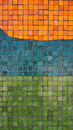 Abstract tile mosaic with orange, blue, and green sections
