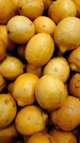Close-up of a pile of fresh yellow lemons in a portfolio.