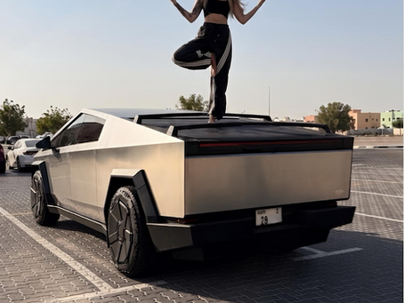 Yoga teacher filming a pose on a Cybertruck, an unexpected hook to get more views