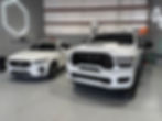 White Volvo SUV and Ram truck after getting full detail and ceramic coating.