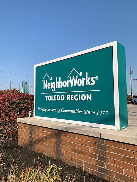 Image showing NeighborWorks Toledo Region Sign with Logo and tagline, "Developing Strong Communities Since 1977."