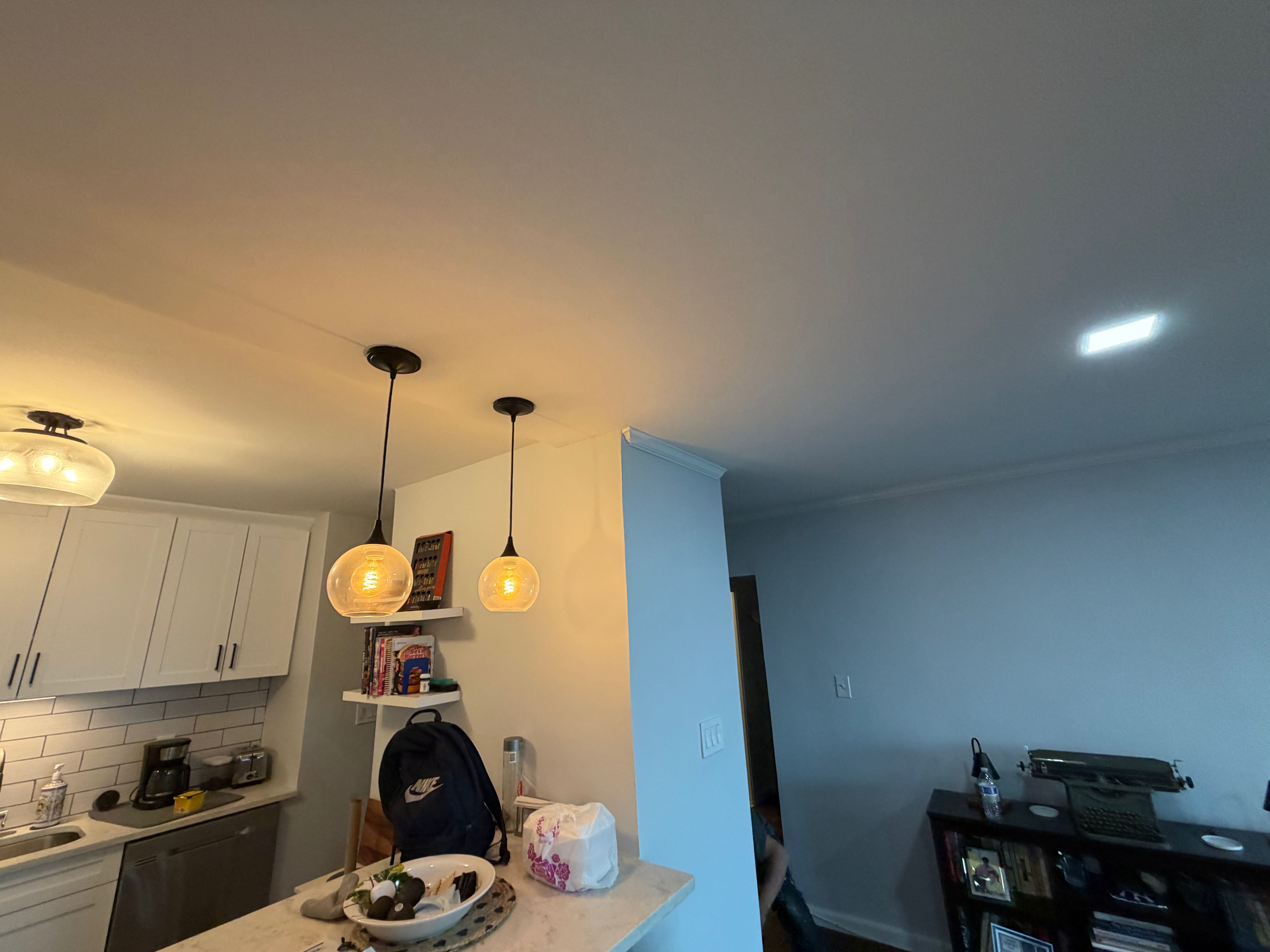 Kitchen remodel in Bergen County, NJ — white shaker cabinets, pendant lights, subway-tile backsplash, marble counter