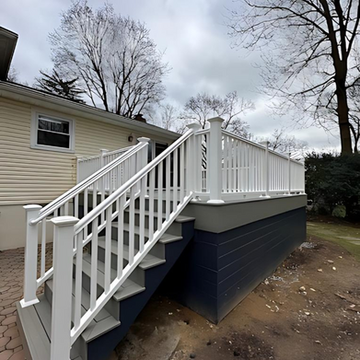 Finished deck with blue siding by Innovative Home Improvement.