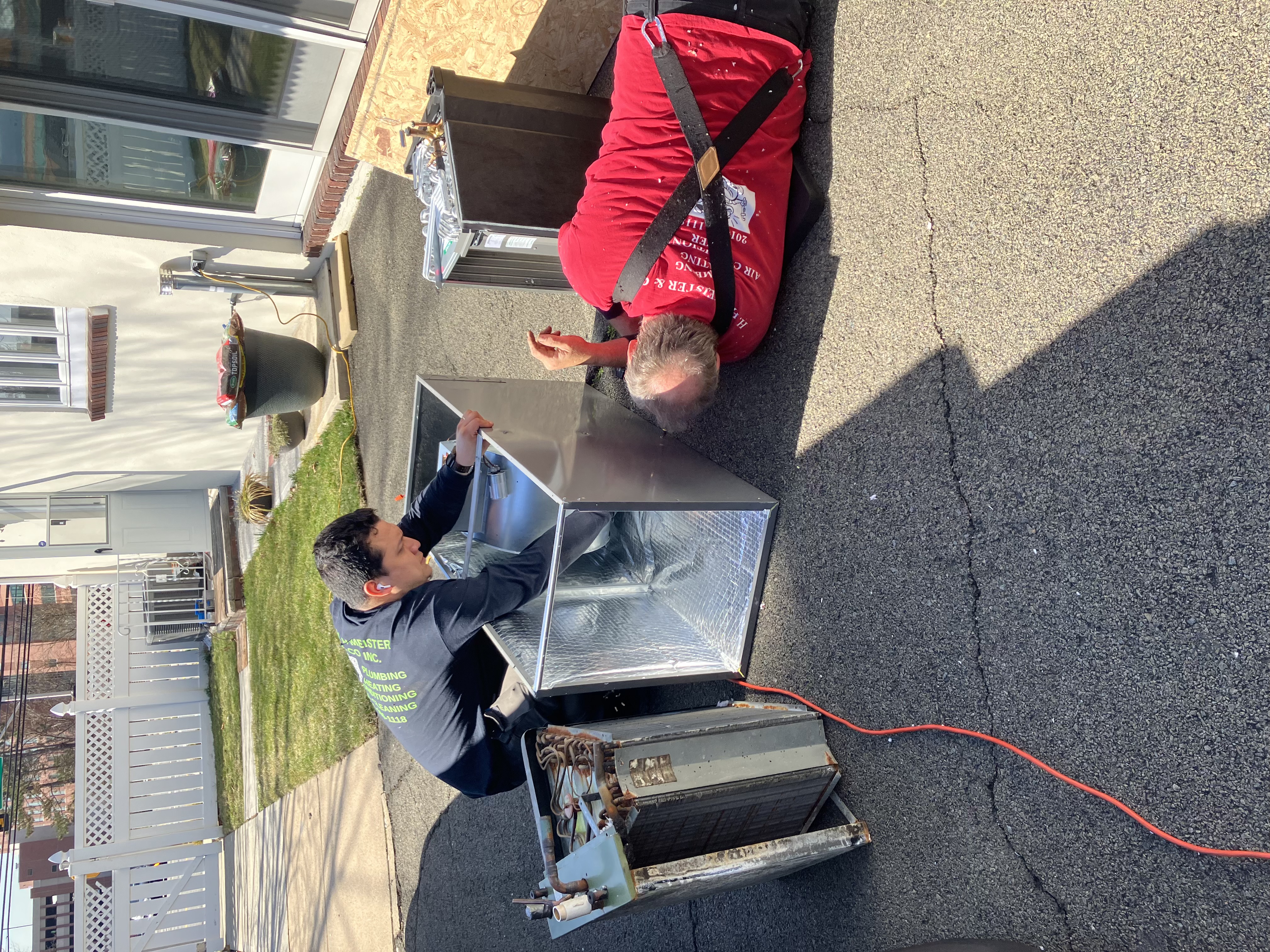 HVAC technician installing a ductless mini split on the exterior of a Park Ridge NJ home